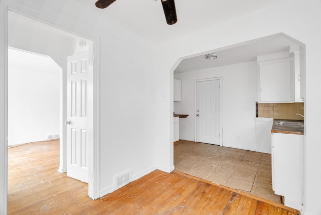 interior space with ceiling fan, sink, and hardwood / wood-style floors