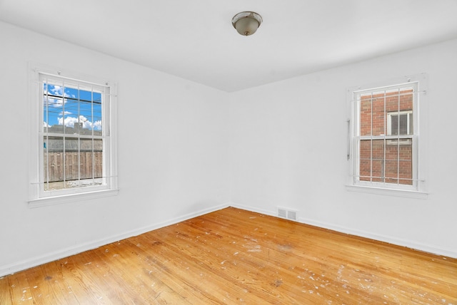 empty room with hardwood / wood-style flooring