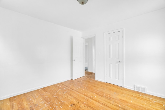 unfurnished room with hardwood / wood-style floors