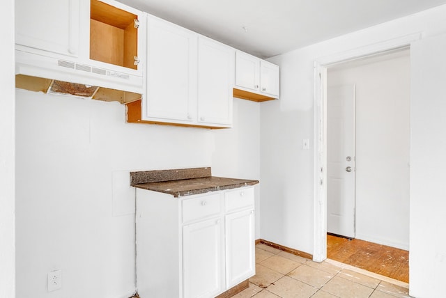 kitchen featuring white cabinetry and light tile patterned floors