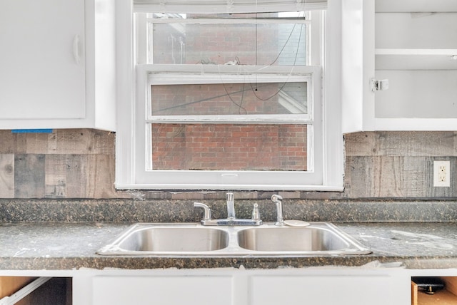 details featuring white cabinetry and sink