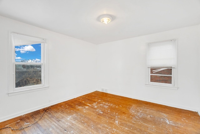 spare room with hardwood / wood-style floors