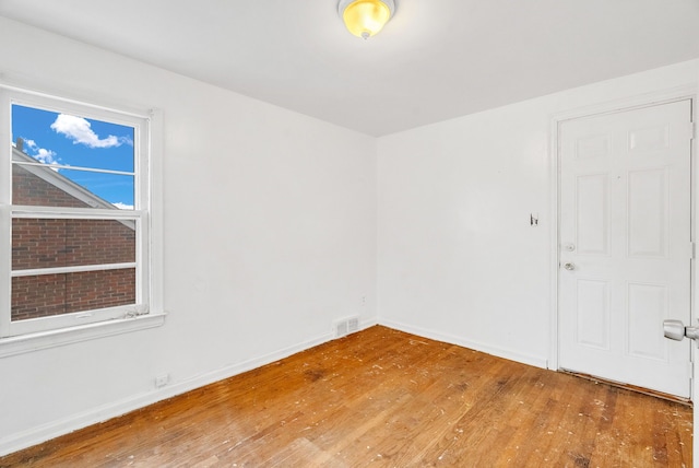 empty room with wood-type flooring