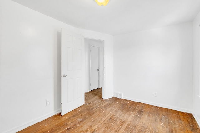 spare room featuring hardwood / wood-style floors