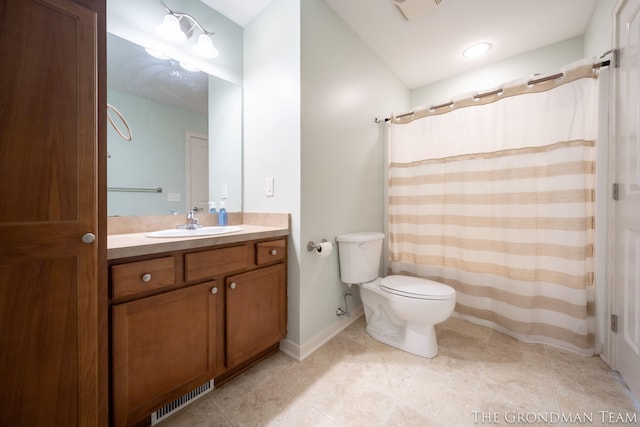 bathroom with tile patterned floors, vanity, and toilet