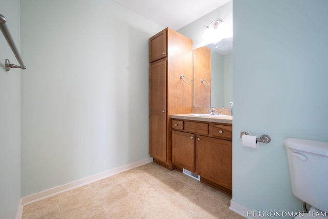 bathroom with vanity, toilet, and tile patterned flooring