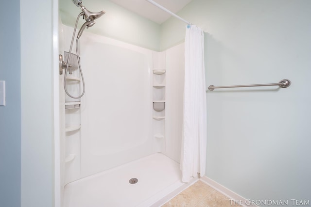 bathroom featuring curtained shower and tile patterned flooring