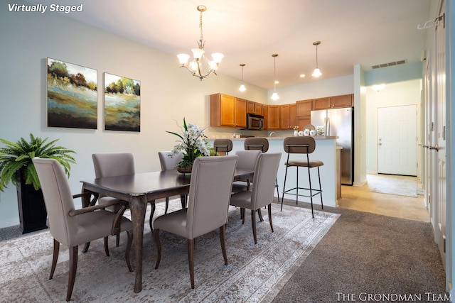 dining space featuring a notable chandelier