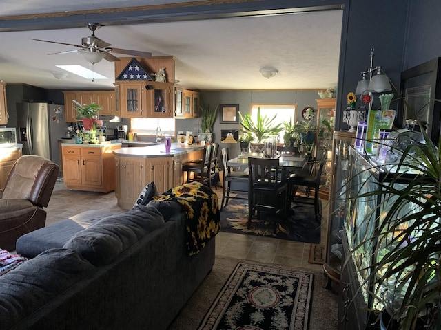 living room featuring ceiling fan and sink