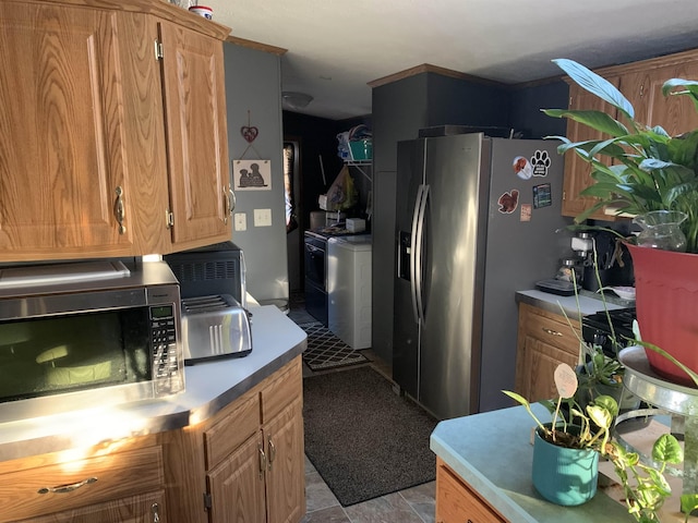 kitchen featuring washer / clothes dryer and appliances with stainless steel finishes