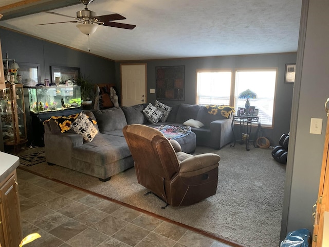 living room featuring lofted ceiling, ceiling fan, carpet, and a textured ceiling