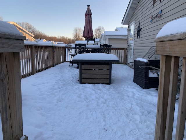 yard covered in snow featuring a deck