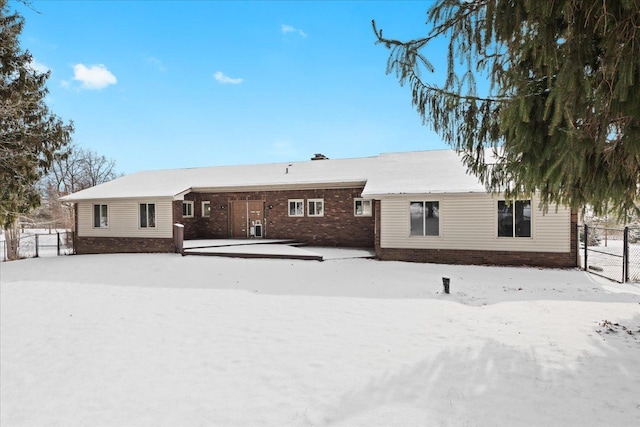 view of snow covered rear of property