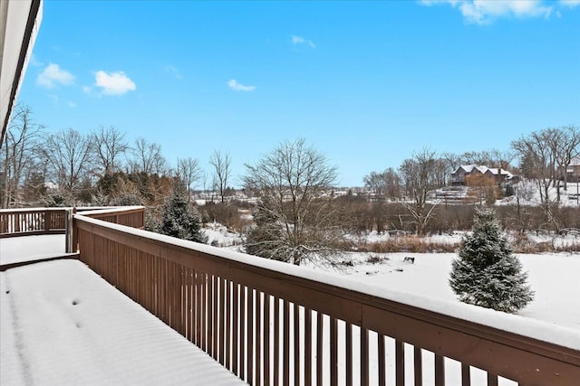 view of snow covered back of property