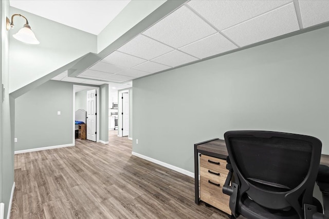 office area featuring hardwood / wood-style floors and a drop ceiling