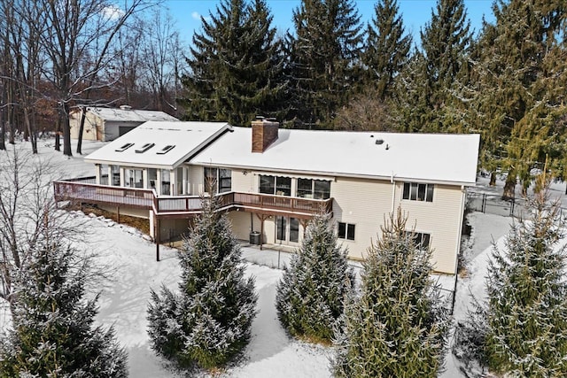 snow covered house with a deck