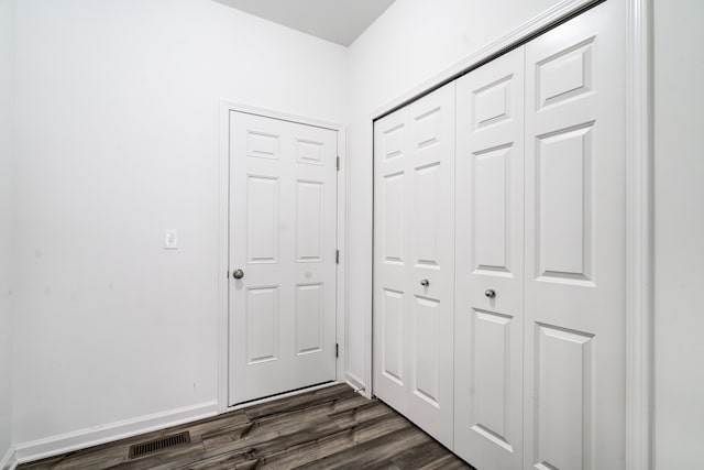 corridor with dark wood-type flooring