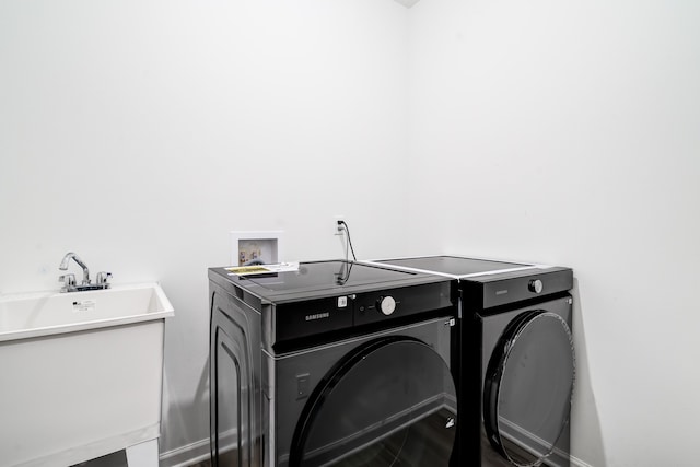 washroom with sink and separate washer and dryer