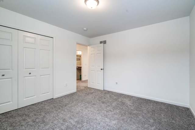 unfurnished bedroom with a closet and carpet