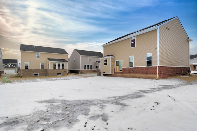 snow covered property featuring central AC