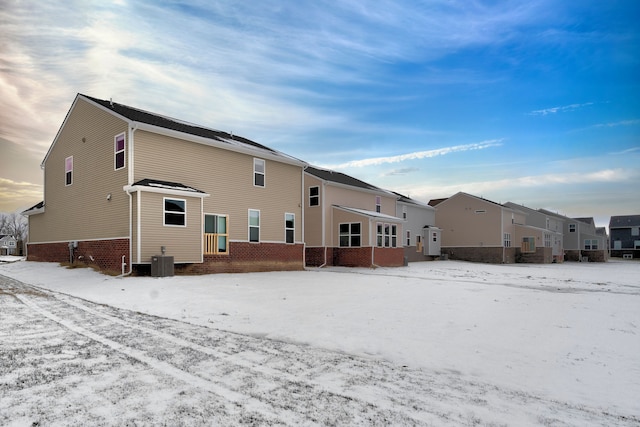 snow covered house with cooling unit