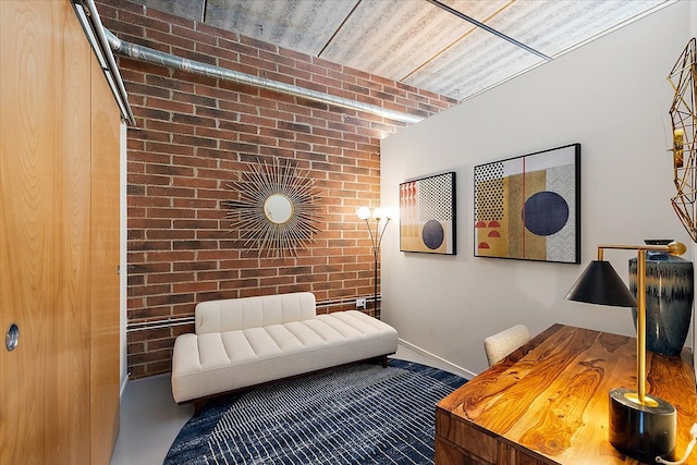 interior space featuring brick wall