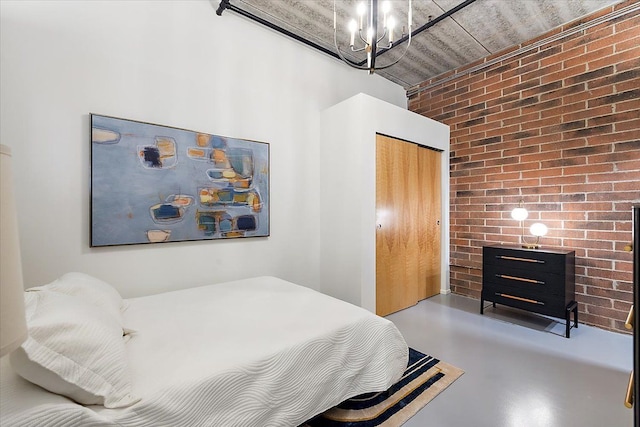 bedroom with concrete floors, a closet, brick wall, a fireplace, and a towering ceiling