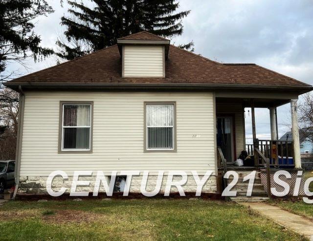 rear view of property with a yard