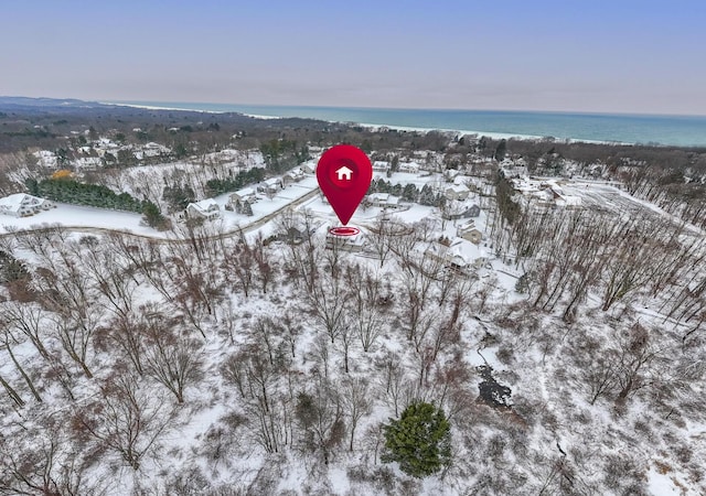 snowy aerial view featuring a water view