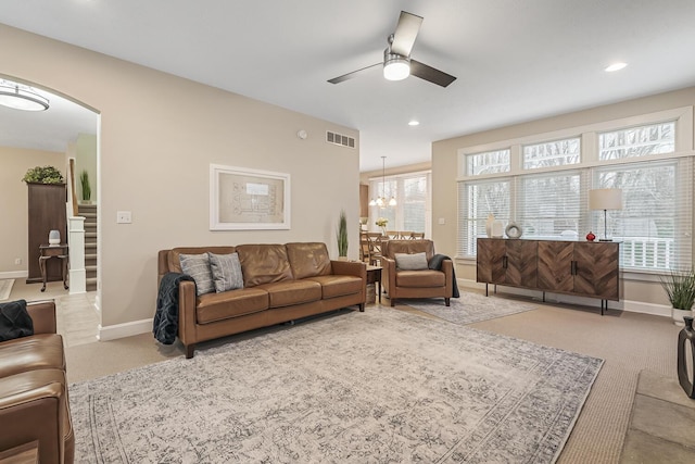 living room with ceiling fan and light colored carpet