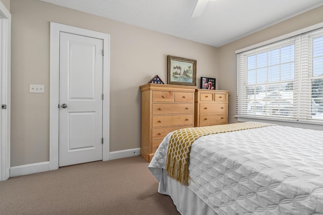 bedroom with ceiling fan and light carpet