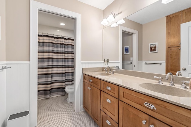 bathroom featuring toilet, vanity, tile patterned flooring, and curtained shower