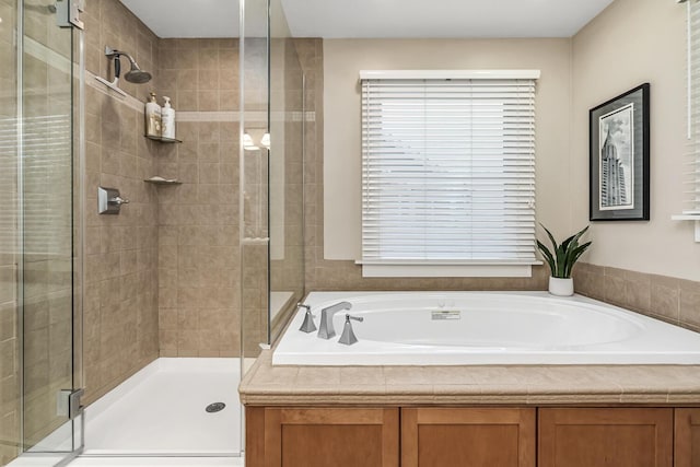 bathroom featuring shower with separate bathtub