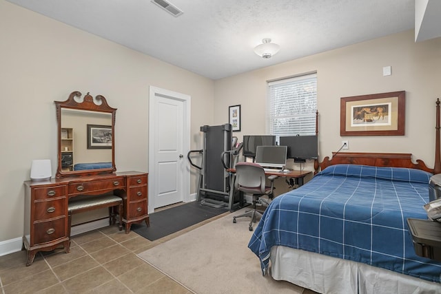 tiled bedroom featuring a textured ceiling