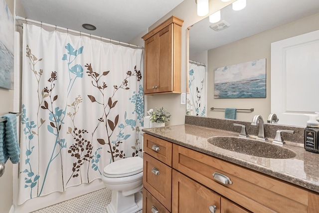 bathroom with toilet, a shower with curtain, tile patterned floors, and vanity