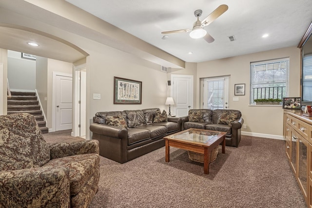 carpeted living room featuring ceiling fan