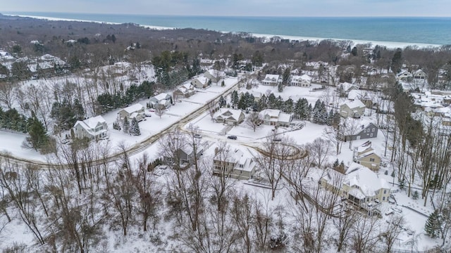 snowy aerial view featuring a water view