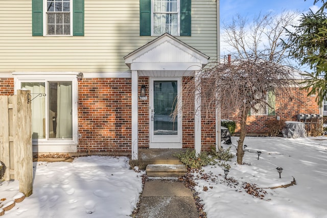 view of snow covered property entrance