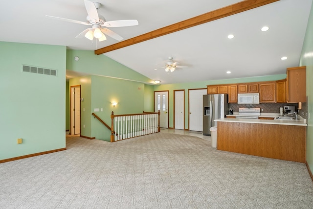 kitchen with white appliances, ceiling fan, vaulted ceiling with beams, tasteful backsplash, and kitchen peninsula