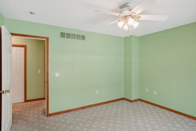 unfurnished room featuring light colored carpet and ceiling fan