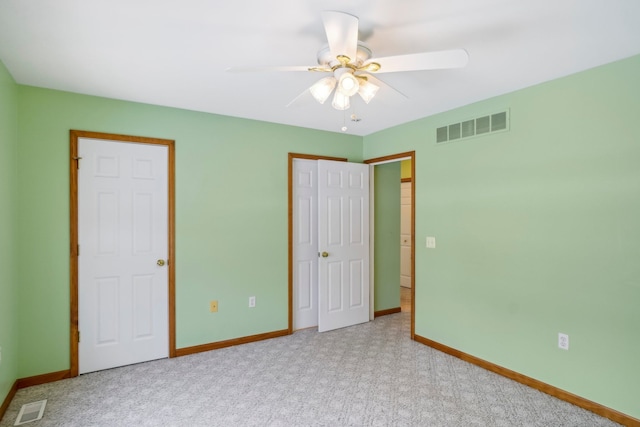 unfurnished bedroom featuring light colored carpet, ceiling fan, and a closet