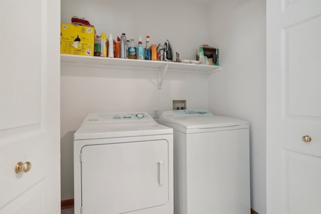 clothes washing area featuring washer and clothes dryer