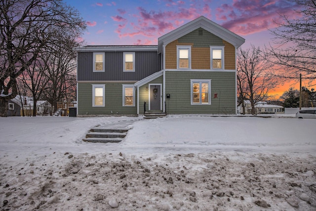 view of snow covered rear of property