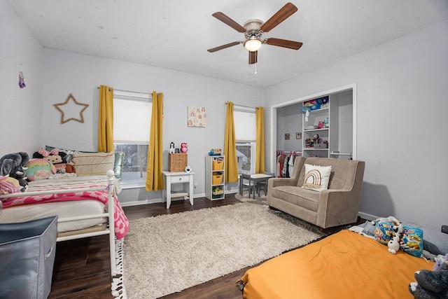 bedroom with ceiling fan and dark hardwood / wood-style floors