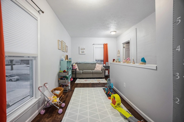 playroom featuring hardwood / wood-style flooring and a textured ceiling