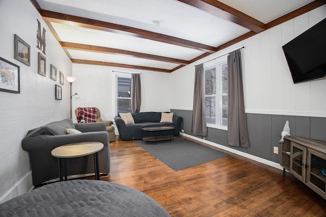 living room featuring dark hardwood / wood-style floors, beam ceiling, and wooden walls