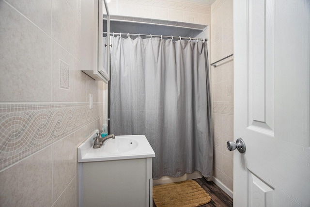 bathroom with wood-type flooring, vanity, and curtained shower