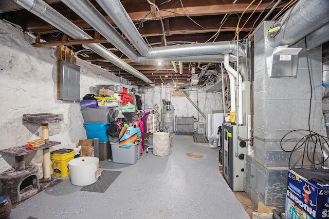 basement featuring washer / dryer, electric panel, heating unit, and gas water heater