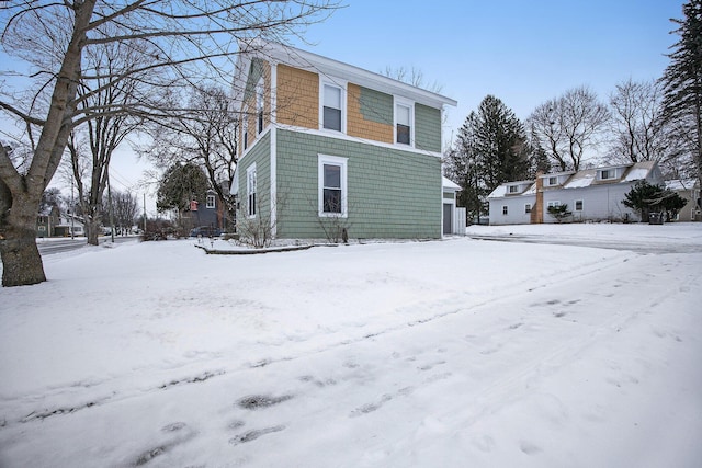 view of snow covered rear of property