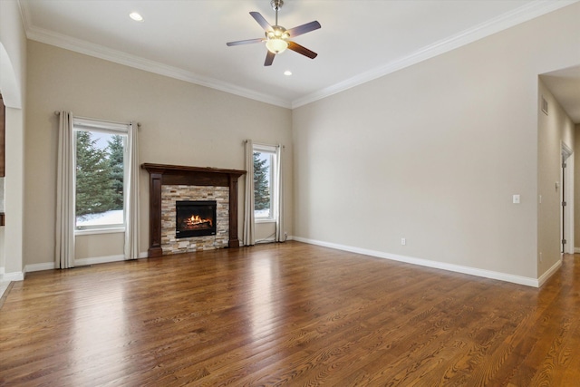 unfurnished living room with a fireplace, ceiling fan, dark hardwood / wood-style flooring, and plenty of natural light